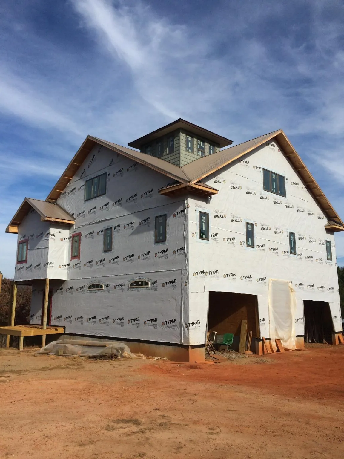 New two story house under construction with a cupola and gabled roofs in Jamestown
